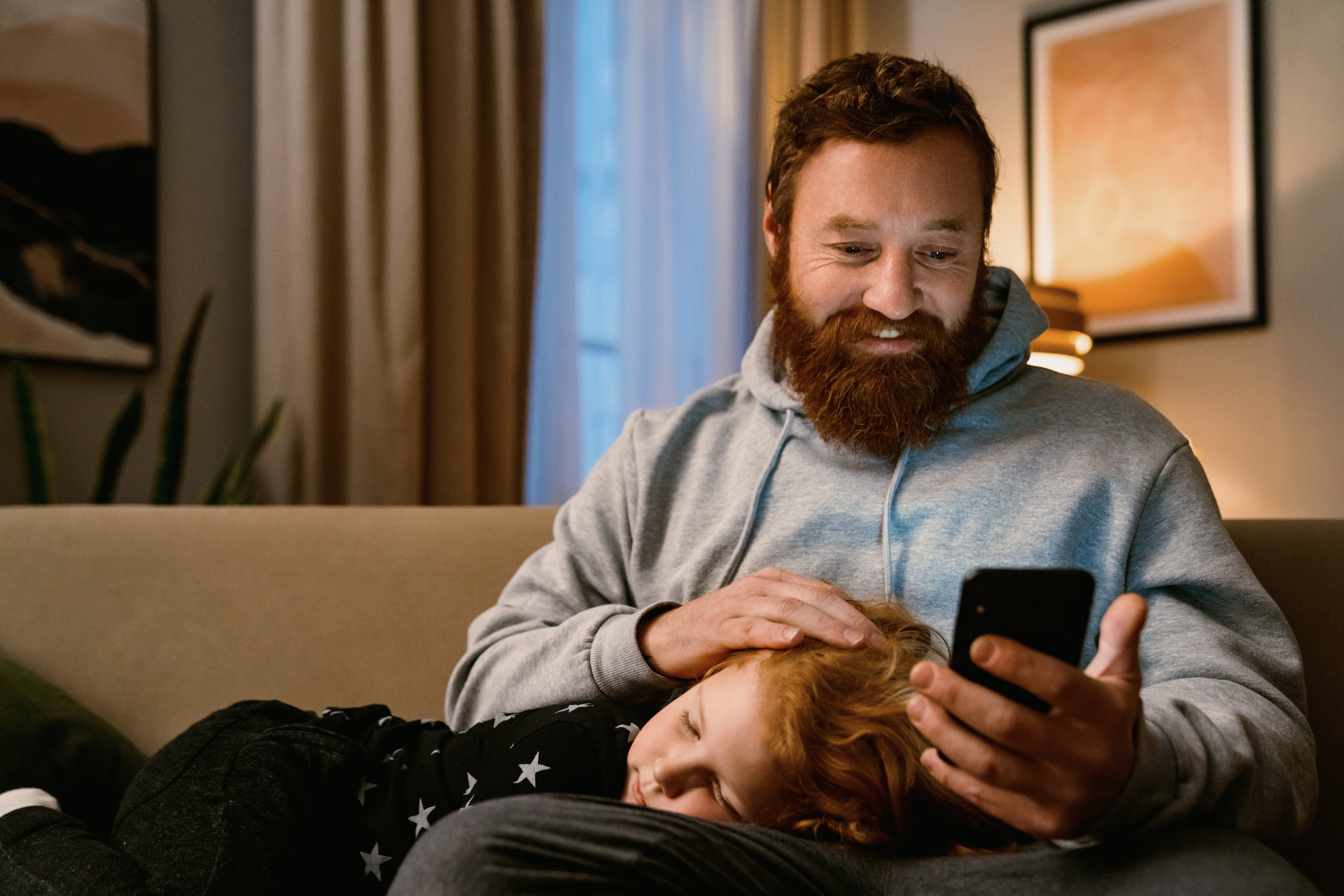 parent at home on his phone