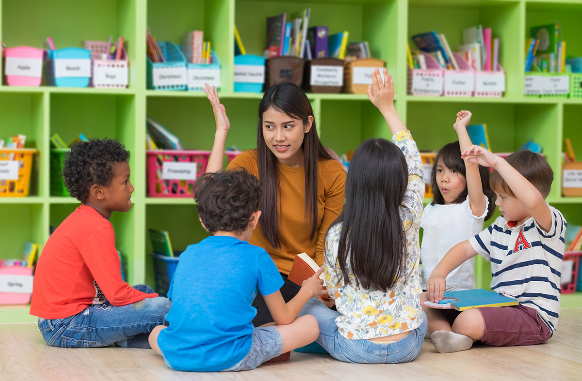 Primary school teacher and students playing game